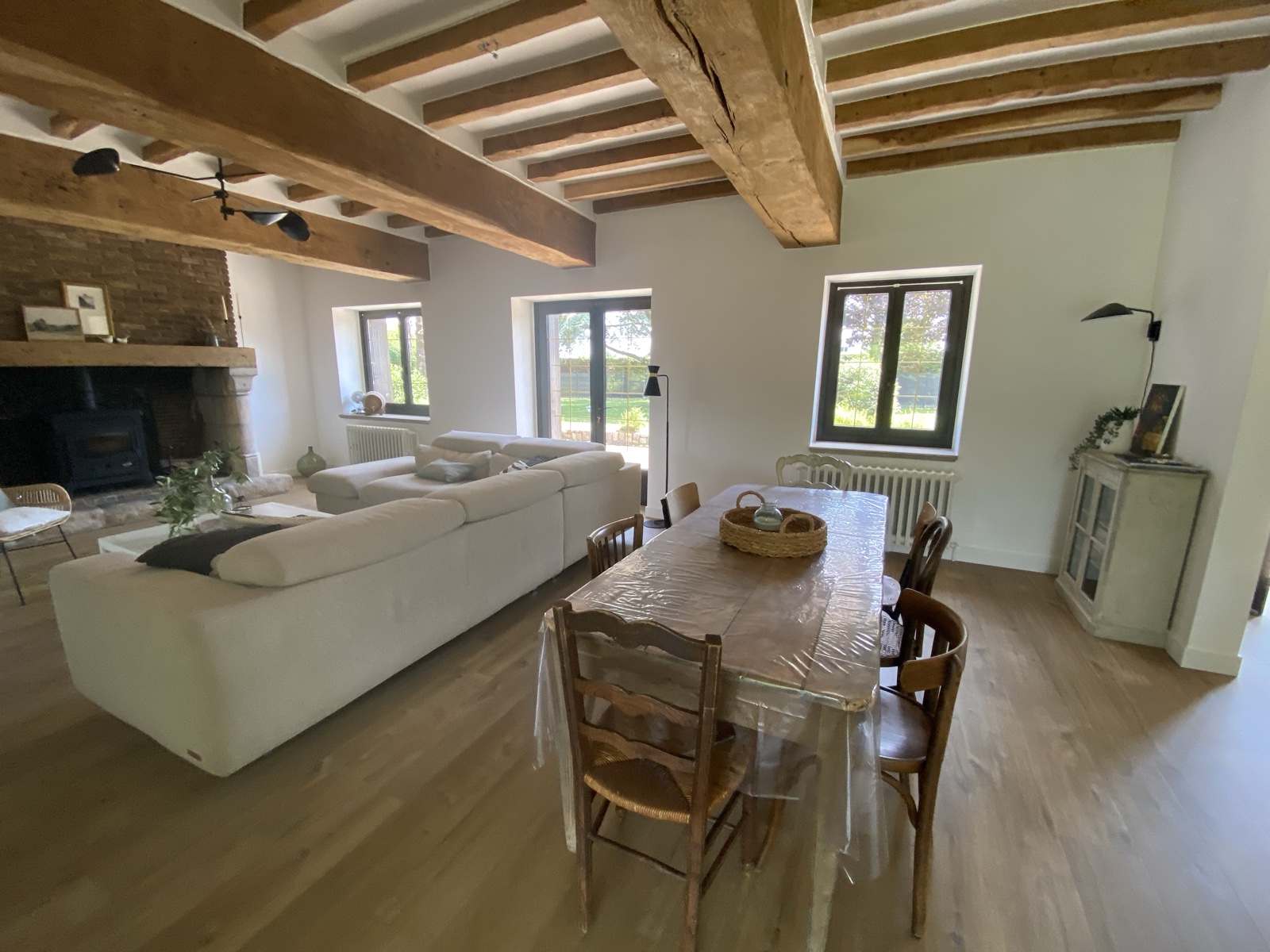 Salon with stone fireplace and Norman beams